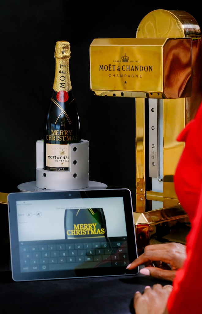 Attendant adding a personal message to a Moët & Chandon bottle