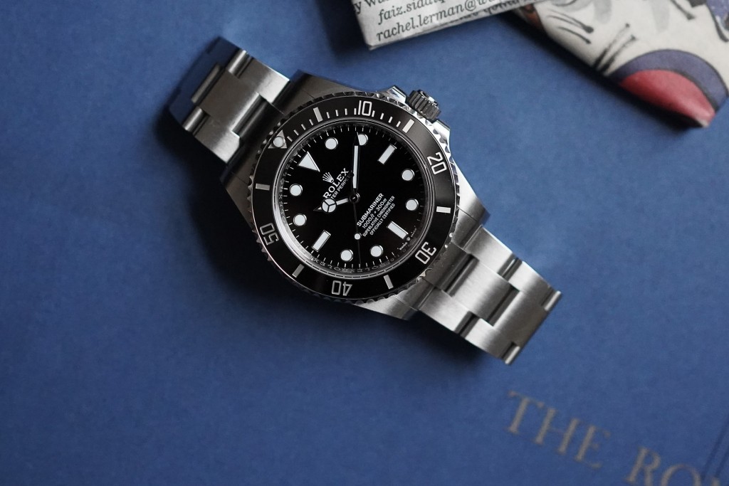 A Rolex watch against a navy blue background