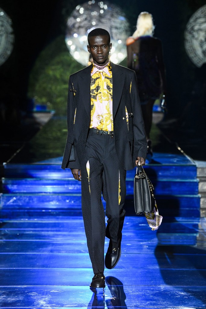 A male model in a Versace by Fendi suit