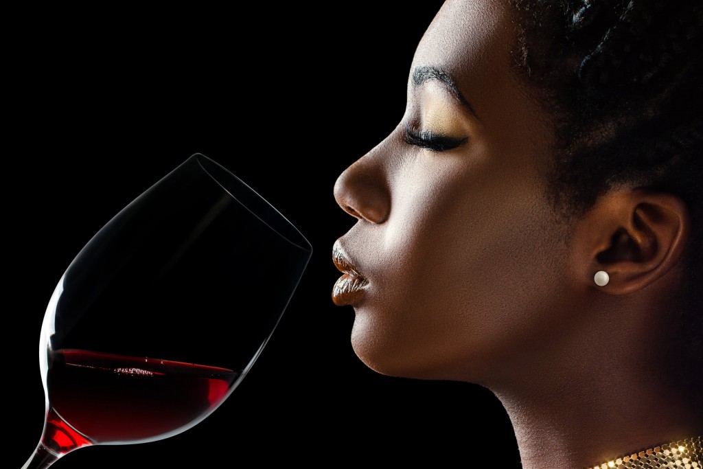 African woman tasting wine