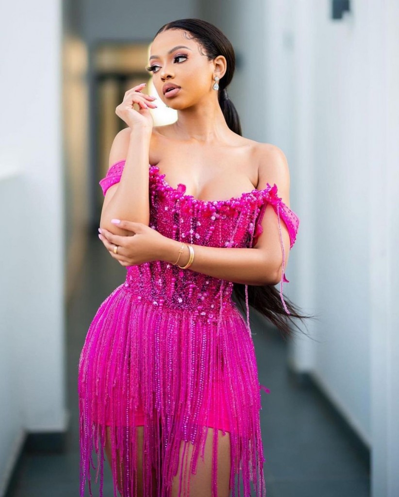 A woman in a pink sequined dress from Keys Fashion
