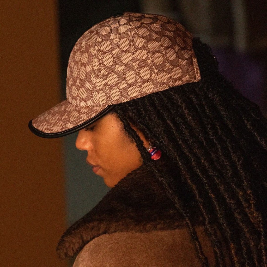 A woman wearing a Coach baseball cap