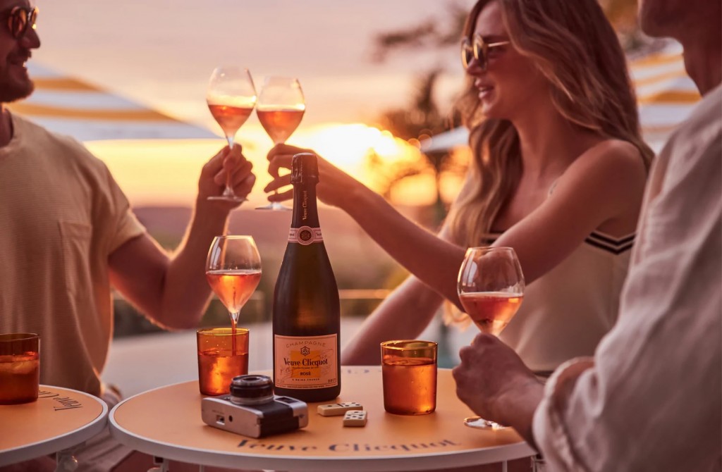 guests drinking a bottle of veuve clicquot